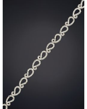 412-PULSERA DE FINAS ONDAS DE BRILLANTES sobre una montura de oro blanco de 18k.