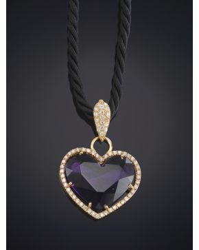 565-COLGANTE DE CORAZÓN DE AMATISTA REMATADO POR BRILLANTES con montura en oro rosa de 18K. Pende un cordón negro de seda.