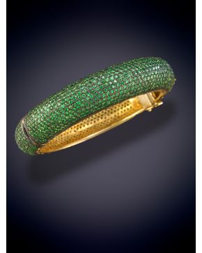 128-ELEGANTE BRAZALETE CUAJADO DE TSAVORITAS sobre una montura en oro de 18K y plata.