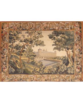 1035-Decorativo tapiz con vista del Monasterio de San Lorenzo del Escorial. España, s. XX, Real Fábrica de Tapices. Cenefa de roleos vegetales y flores. Medidas: 200x260 cm.