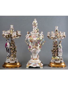 816-Grupo formado por jarrón con candelabros de siete luces  en porcelana de Sajonia, S.XIX, decorado con personajes de bulto redondo y flores aplicadas.   Altura mayor: 75 cm 