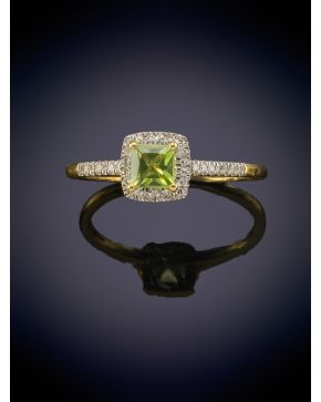 408-ELEGANTE SORTIJA CON UN PERIDOTO CENTRAL ORLADO Y FLANQUEADO POR BRILLANTES sobre una montura en oro amarillo de 18K.