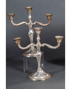 1138-Pareja de candelabros modelo cordón  de tres luces en plata española punzonada con marcas de montejo. Peso total (contrapeso): 1.610 gr. Altura:"