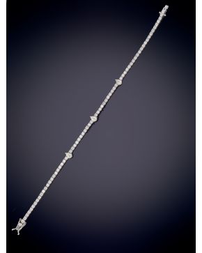 736-FINA PUSLERA RIVIERE DE BRILLANTES CON TRES DIAMANTES TALLA PERA DISPUESTOS EN EL CENTRO CON UN PESO TOTAL DE 3,35CT. APROX. Sobre una m