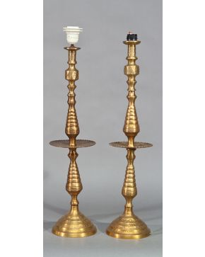 2316-Pareja de candeleros de estilo morisco en metal dorado. Alturas: 64 y 66 cm